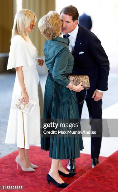 Crown Princess Marie-Chantal of Greece looks on as Crown Prince Pavlos of Greece kisses his mother Queen Anne-Marie of Greece as they attend a...