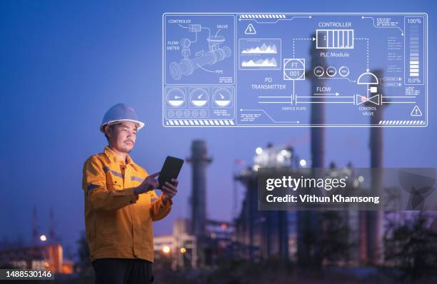 male engineer working with tablet at power station technology concept - green energy icons stock pictures, royalty-free photos & images