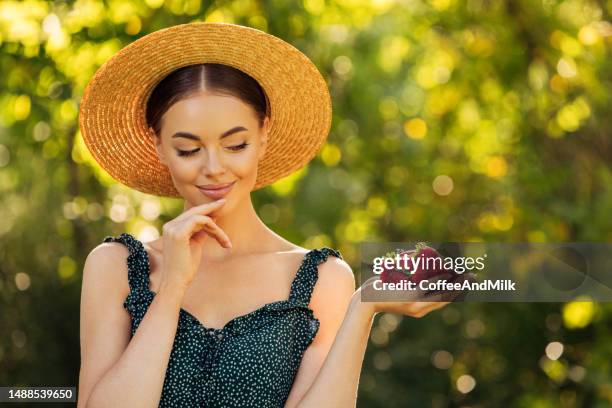 attractive girl with strawberries - handful stock pictures, royalty-free photos & images