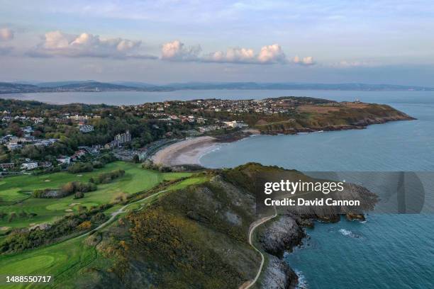 An aerial view of the par 3, 16th hole on the cliff edge looking towards the village of Newton, Langland Bay and The Mumbles at Langland Bay Golf...