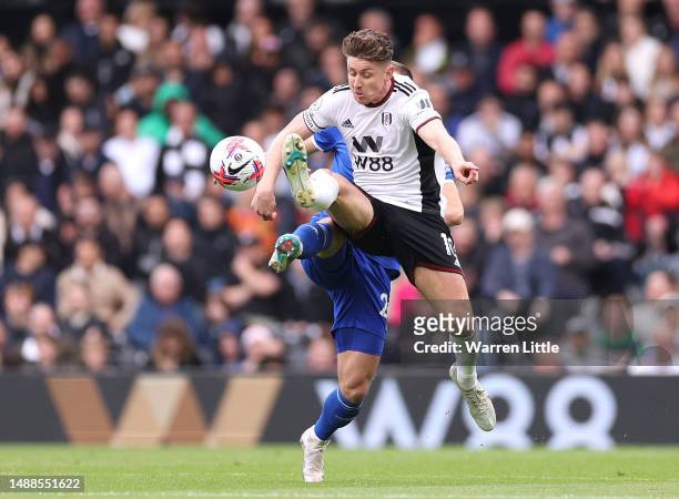 Tom Cairney of Fulham is tackled by Dennis Praet of Leicester City during the Premier League match between Fulham FC and Leicester City at Craven...