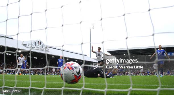 Tom Cairney of Fulham scores the team's fourth goal as Daniel Iversen of Leicester City fails to make a save during the Premier League match between...