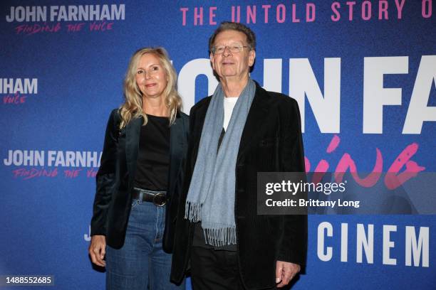 Red Symons and guest attend the Australian premiere of "John Farnham: Finding the Voice" at the Astor Theatre on May 09, 2023 in Melbourne, Australia.