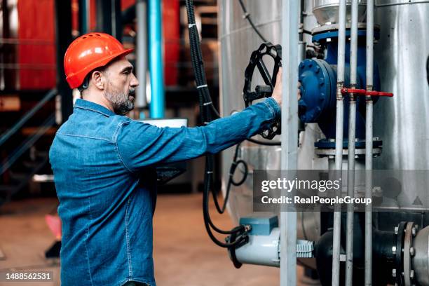 heating plant engineer checking the valve - gas turbine stock pictures, royalty-free photos & images