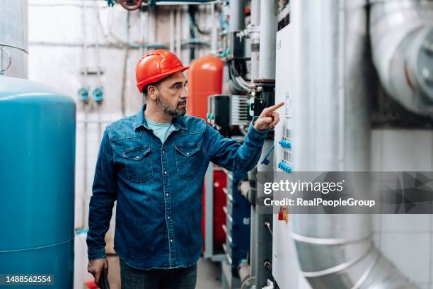 checking the switches - district heating plant stock pictures, royalty-free photos & images