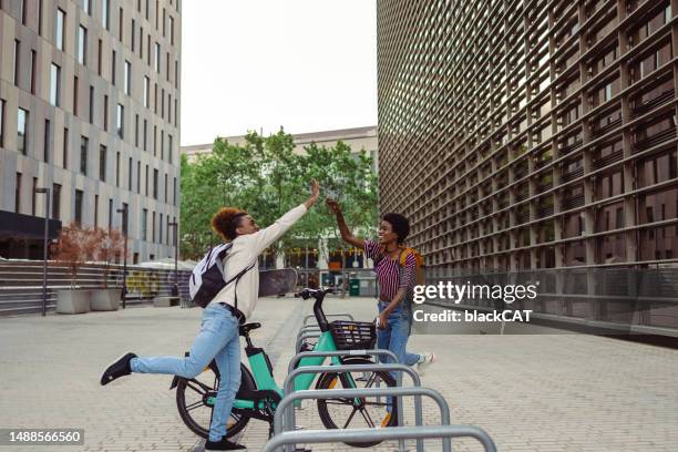 cheerful young people on the street - sharing economy stockfoto's en -beelden