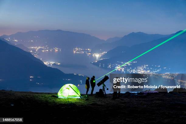 family admiring stars with telescope, lake como - stämningsfull bildbanksfoton och bilder