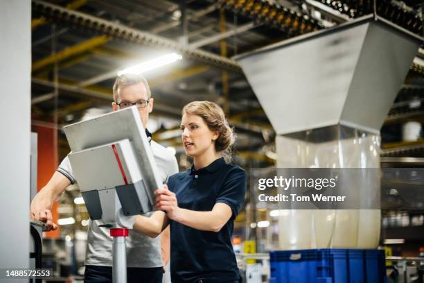 two engineers working on control panel of a machine - 40 44 years blond hair mature man factory stock pictures, royalty-free photos & images