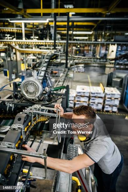 worker checking machine parts of a conveyor - 40 44 years blond hair mature man factory stock pictures, royalty-free photos & images