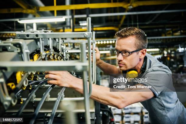 engineer checking machine parts of a heavy machine - big tom stock-fotos und bilder