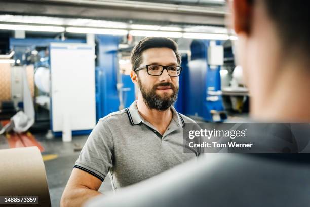 manager and workers talking in paper roll warehouse - casual businessman glasses white shirt stock pictures, royalty-free photos & images