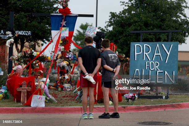 People visit the memorial setup near the scene of a mass shooting at the Allen Premium Outlets mall on May 9, 2023 in Allen, Texas. Eight people were...