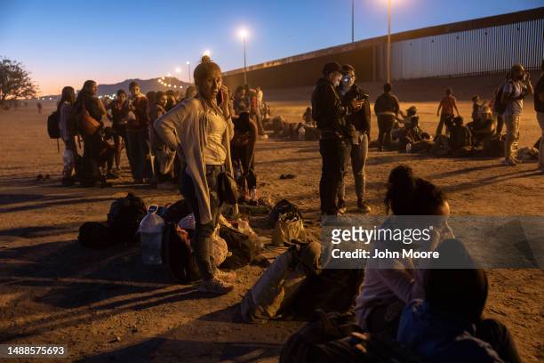 Immigrants seeking asylum in the United States wait near the U.S. Mexico border fence, hoping to be processed by U.S. Border agents to make asylum...