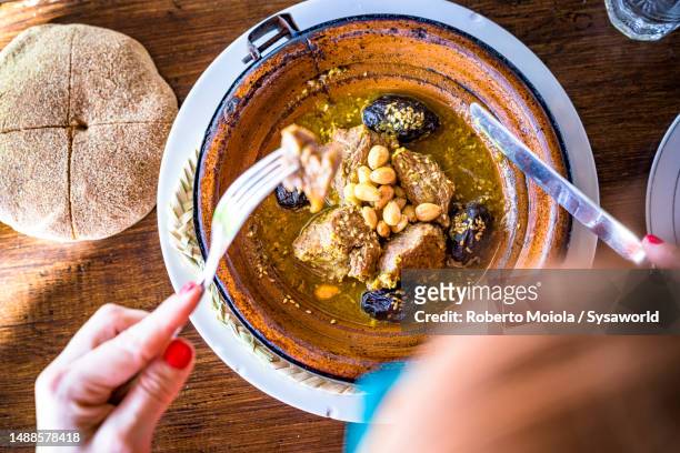 personal perspective of woman eating tajine - tajine stock pictures, royalty-free photos & images