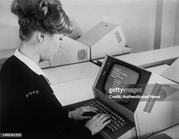 Ticket agent enters information into a computer terminal with a CRT monitor to access flight information from an unspecified office in the United...