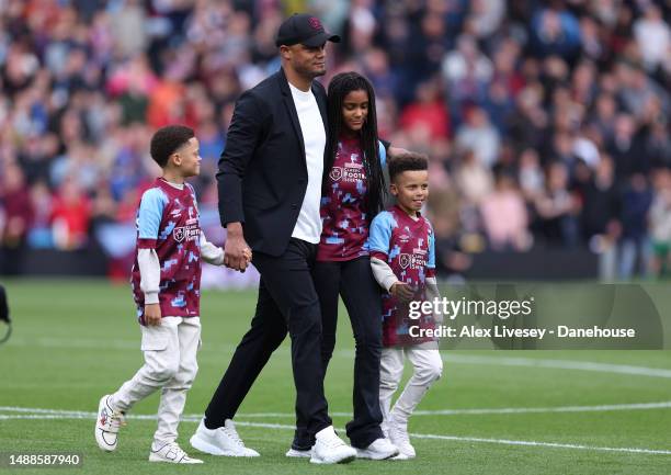 Vincent Kompany, Manager of Burnley, walks onto the pitch with their children after walking through a guard of honour formed by players of Cardiff...