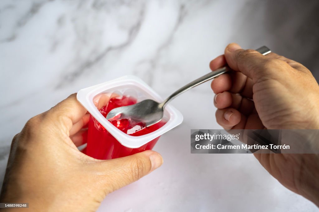 Woman Eating Red Gelatin.