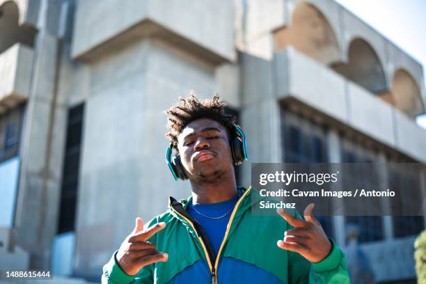 african american man with headphones. gesturing with his hands - castilla la mancha stock-fotos und bilder