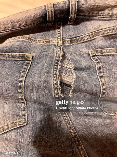 rip in a pair of jeans. - torn clothes stock pictures, royalty-free photos & images