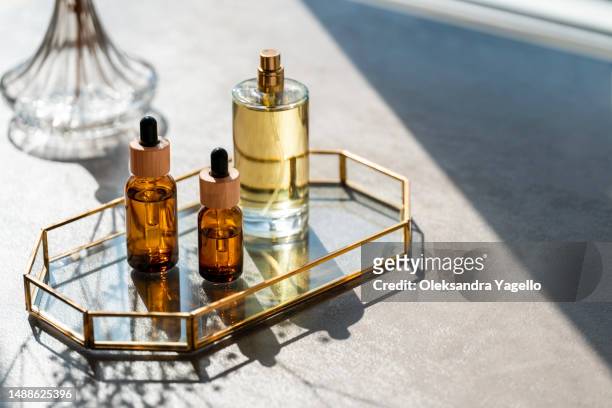 cosmetic products and mirror on table. unrecognizable bottles of perfume and samplers. beauty concept - 匂い ストックフォトと画像