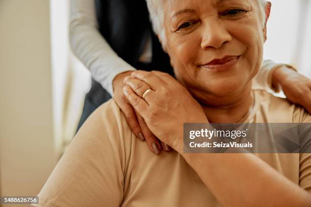 elderly woman, caregiver and healthcare in a nursing home with hand on shoulder for support. face of senior female patient with a nurse for healing, trust and empathy or therapy with health insurance - hand shoulder stock pictures, royalty-free photos & images