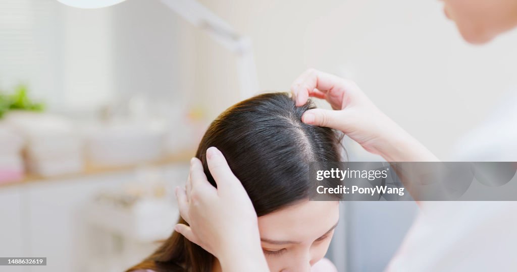 医師は手で頭皮を調べます