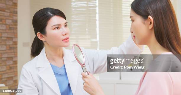 woman ask face aesthetic treatment - dermatologists talking to each other patient stock pictures, royalty-free photos & images