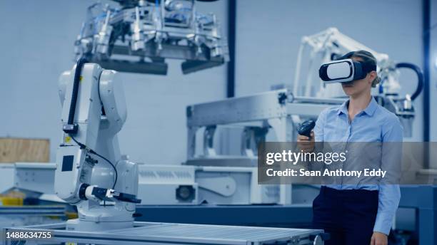 engineering, robotics and woman in vr glasses and joystick for ai, futuristic electronics and manufacturing in industry 4.0. robot design, workshop and technician person in virtual reality of machine - industry 4 0 imagens e fotografias de stock