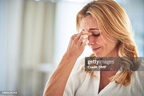 woman with stress headache, crisis and mental health problem, sad with depression and anxiety. mockup house, confused or tired with brain fog, female person with worried face and burnout issues - 40 44 years stock pictures, royalty-free photos & images