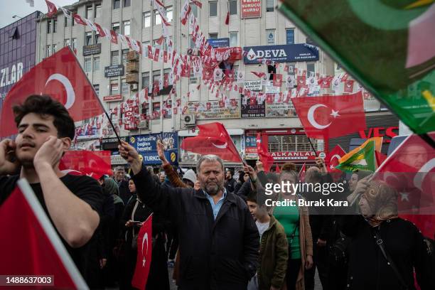 Supporters of Turkey's President Recep Tayyip Erdogan wave national, AK Party and Huda Par flags during a campaign event on May 09, 2023 in Istanbul,...