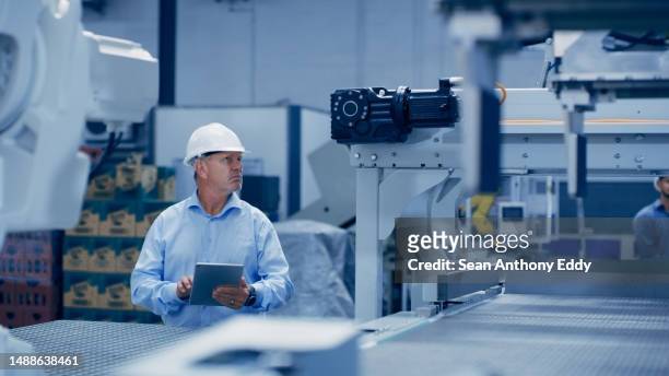 factory, machine and engineering man with tablet for maintenance, programming or manufacturing inspection. technician person with industry 4.0 for electronics, automation design or digital technology - industry 4 0 imagens e fotografias de stock