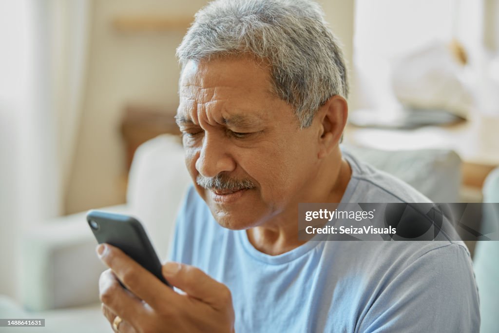 Senior man with smartphone, confused and reading message with vision problem or fail to understand app. Social media, communication and issue with technology and male person in retirement at home