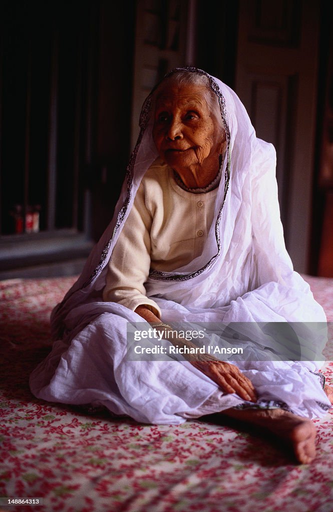 An elderly woman from Calcutta wears the traditional white sari of a widow.