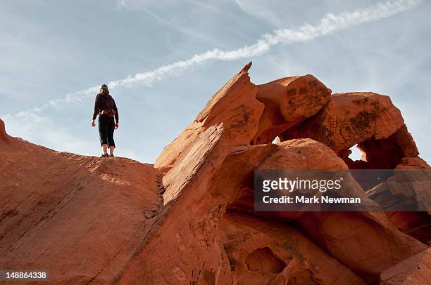 woman atop rock outcrop. - lake mead national recreation area stock pictures, royalty-free photos & images