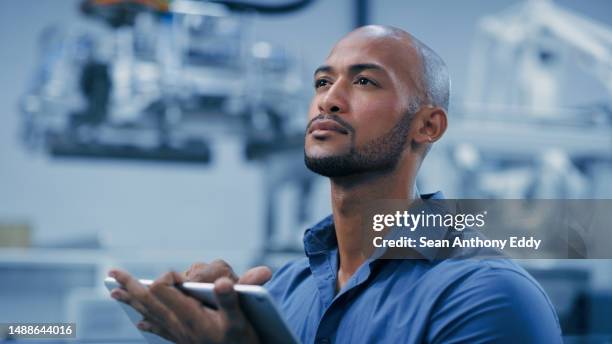 thinking, tablet and robotics with a man engineer working in a factory for machine automation or innovation. industry 4.0, futuristic and technology with a male employee working in a warehouse - industry 4 0 imagens e fotografias de stock