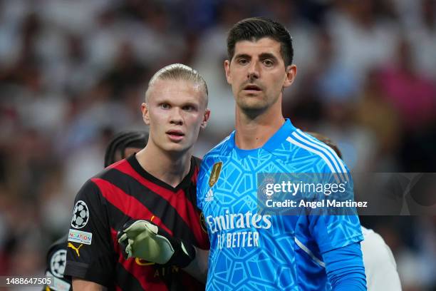 Erling Haaland of Manchester City looks on with Thibaut Courtois of Real Madrid during the UEFA Champions League semi-final first leg match between...