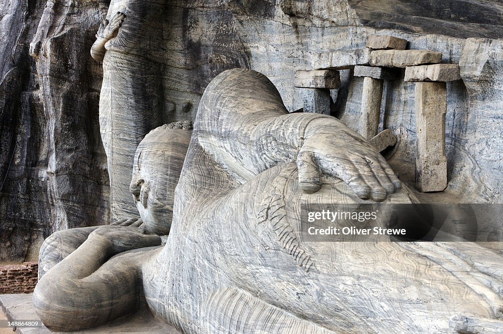 Ancient Sinhalese Buddhas carved into granite rock face at Gal Vihara.