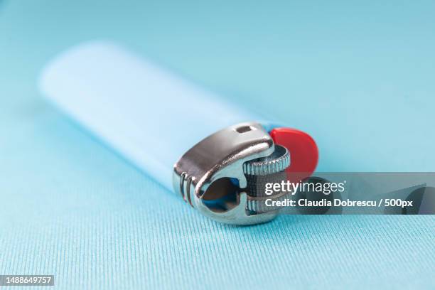 lighter on the blue background - macro detail,romania - cigarette lighter stockfoto's en -beelden