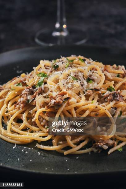 spaghetti pasta with anchovies and onions - anchovy stock pictures, royalty-free photos & images