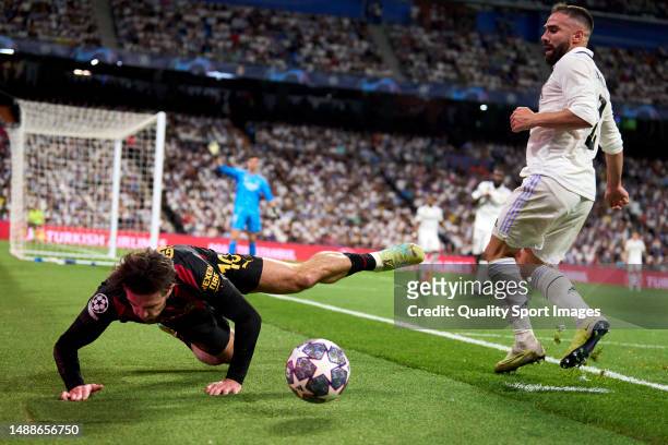 Daniel Carvajal of Real Madrid battle for the ball with Jack Grealish of Manchester City FC during the UEFA Champions League semi-final first leg...