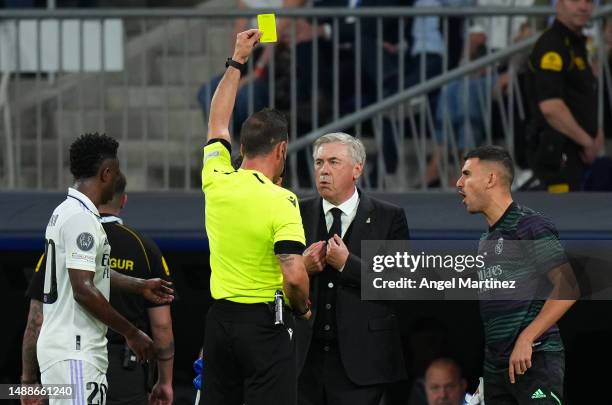Referee Artur Dias Soares shows a yellow card to Carlo Ancelotti, Head Coach of Real Madrid, during the UEFA Champions League semi-final first leg...