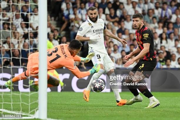 Ederson of Manchester City makes a save from Karim Benzema of Real Madrid during the UEFA Champions League semi-final first leg match between Real...