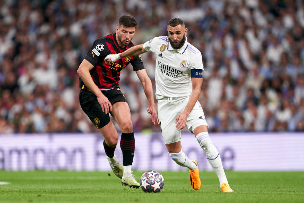 Karim Benzema of Real Madrid competes for the ball with Ruben Dias of Manchester City FC during the UEFA Champions League semi-final first leg match...