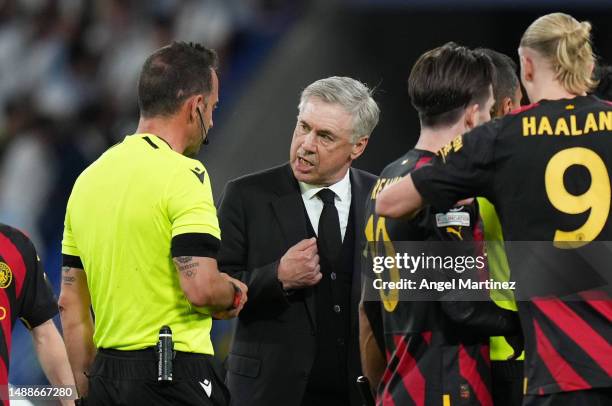 Referee Artur Dias Soares speaks to Carlo Ancelotti, Head Coach of Real Madrid, after the team's draw during the UEFA Champions League semi-final...