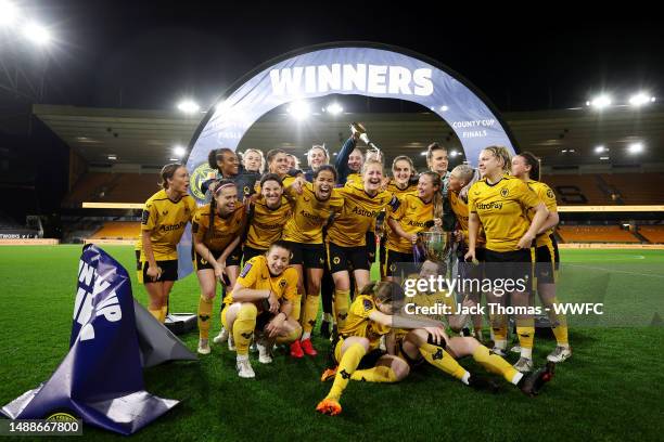 Wolverhampton Wanderers celebrate with the trophy following their teams victory during the Birmingham County Cup Women's Final match between...