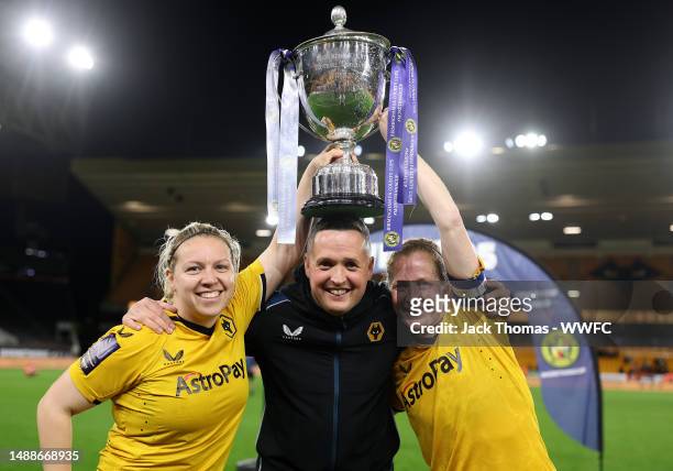 Helen Dermody, Head Coach Daniel McNamara and Anna Price of Wolves celebrate with the trophy following their teams victory during the Birmingham...