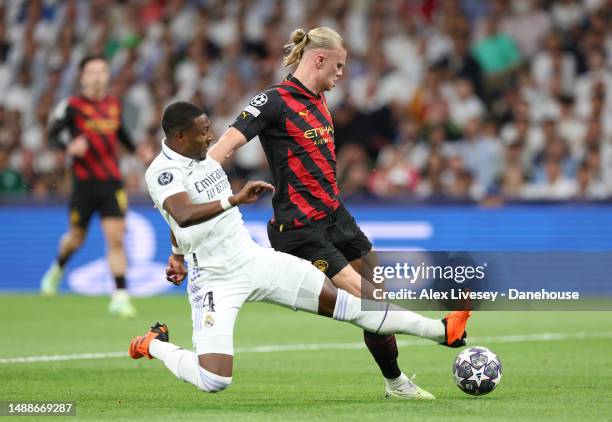 David Alaba of Real Madrid tackles Erling Haaland of Manchester City FC during the UEFA Champions League semi-final first leg match between Real...