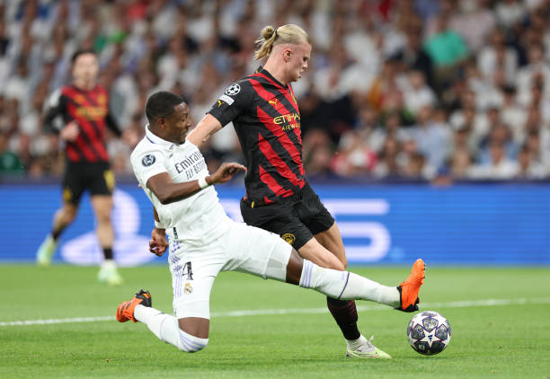 David Alaba of Real Madrid tackles Erling Haaland of Manchester City FC during the UEFA Champions League semi-final first leg match between Real...