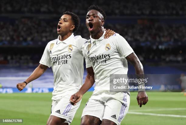 Vinicius Junior of Real Madrid celebrates after scoring the team's first goal with Rodrygo of Real Madrid during the UEFA Champions League semi-final...