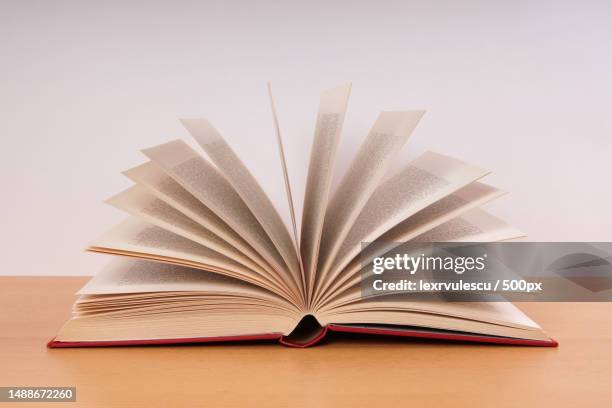 close-up of open book on table,romania - open romania imagens e fotografias de stock